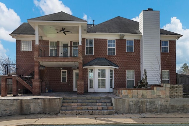 view of front of property with a swimming pool, a balcony, a patio, and ceiling fan