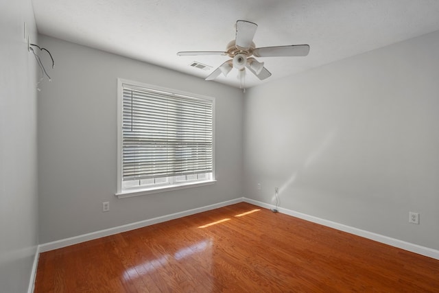 unfurnished room with ceiling fan and wood-type flooring