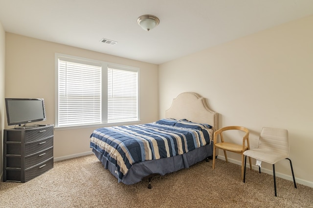 bedroom featuring baseboards and carpet floors