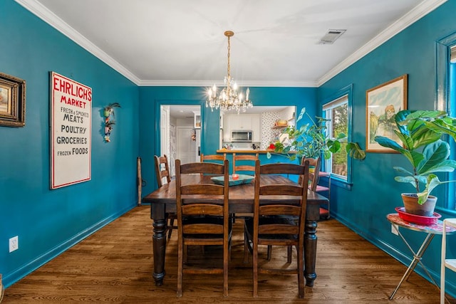 1445 22nd St, Columbus, GA 31901 - dining area with a chandelier, wood finished floors, and crown molding