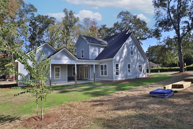 rear view of house featuring a lawn