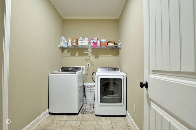 laundry area with light tile patterned floors, crown molding, and independent washer and dryer