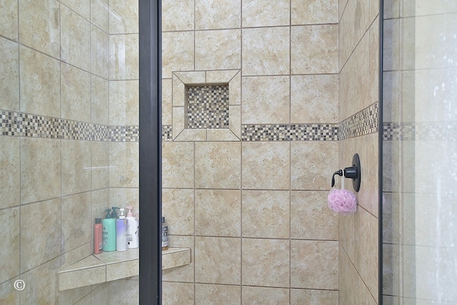 bathroom with tiled shower