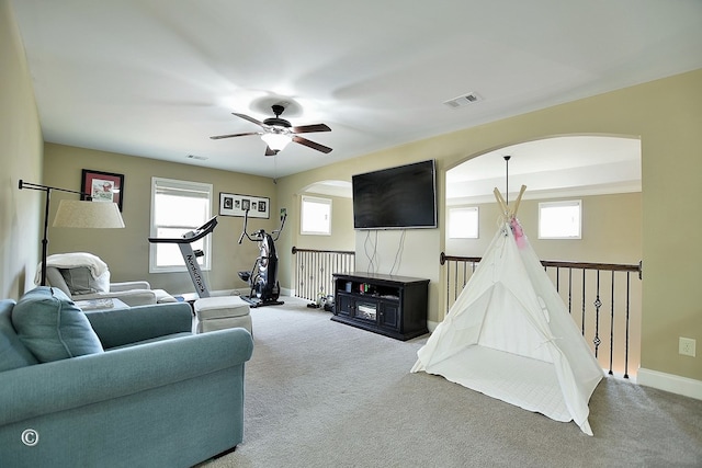 carpeted living room featuring ceiling fan