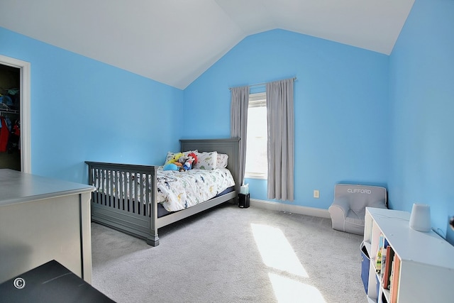 carpeted bedroom featuring vaulted ceiling