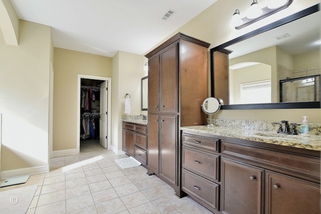 bathroom featuring vanity, an enclosed shower, and tile patterned flooring