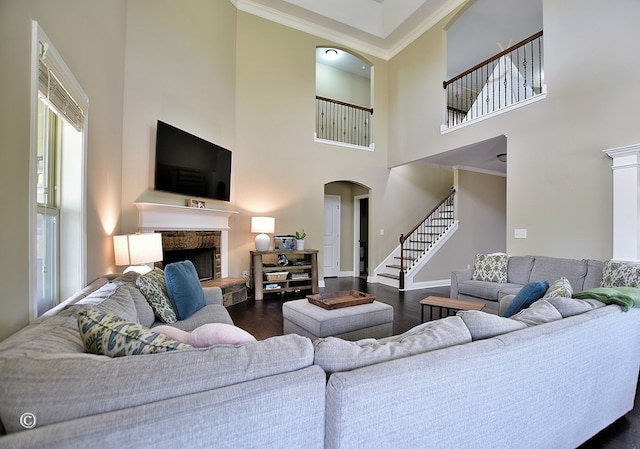 living room featuring ornamental molding, a fireplace, and dark hardwood / wood-style flooring