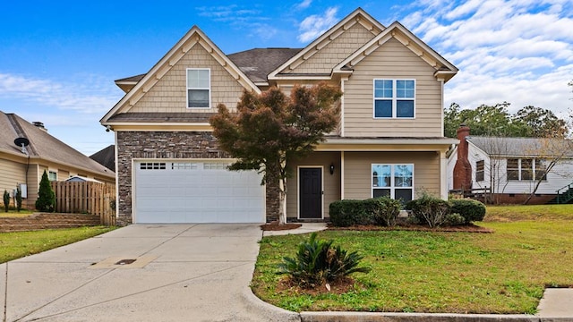 craftsman house with a garage and a front lawn