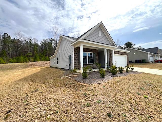 view of front of house with brick siding, concrete driveway, and a garage