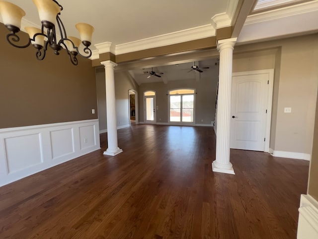 interior space featuring a notable chandelier, dark hardwood / wood-style flooring, ornamental molding, and decorative columns