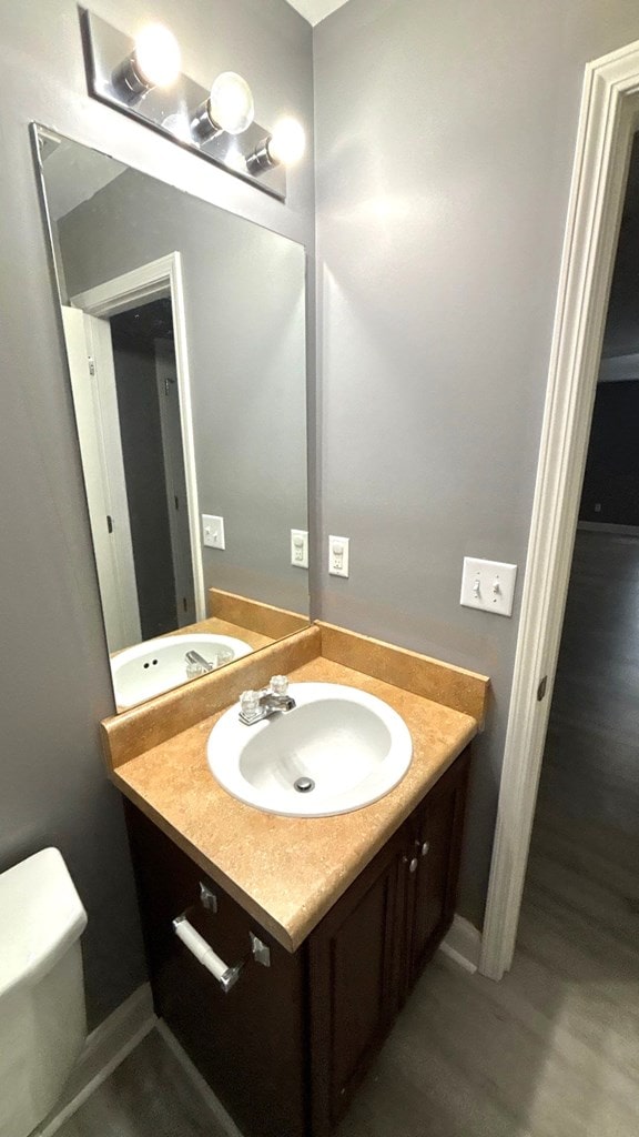 5 Rusty Dr, Phenix City, AL 36869 - bathroom featuring vanity, toilet, and wood finished floors