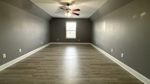 5 Rusty Dr, Phenix City, AL 36869 - unfurnished room featuring a ceiling fan, lofted ceiling, dark wood finished floors, and baseboards