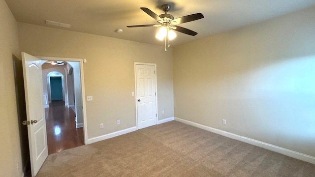 5 Rusty Dr, Phenix City, AL 36869 - unfurnished bedroom with arched walkways, carpet, baseboards, and a ceiling fan