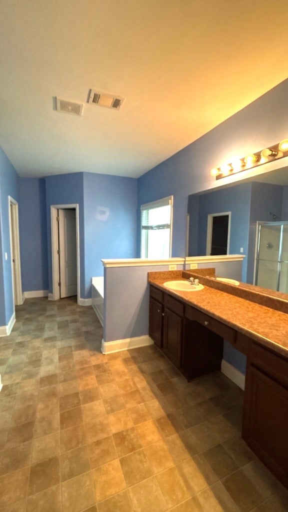 5 Rusty Dr, Phenix City, AL 36869 - full bath with a stall shower, vanity, and baseboards