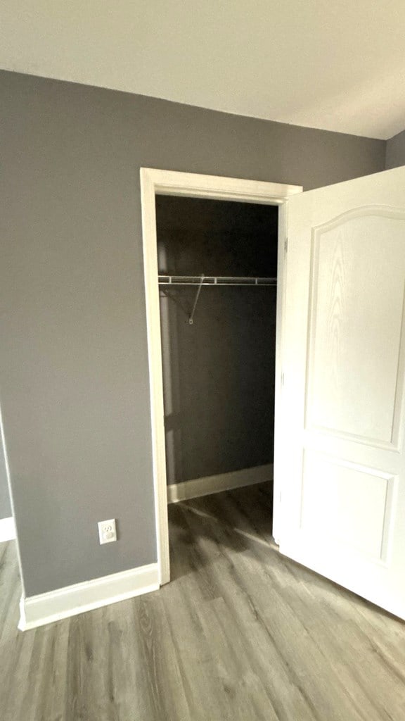 5 Rusty Dr, Phenix City, AL 36869 - unfurnished bedroom featuring wood finished floors, a closet, and baseboards