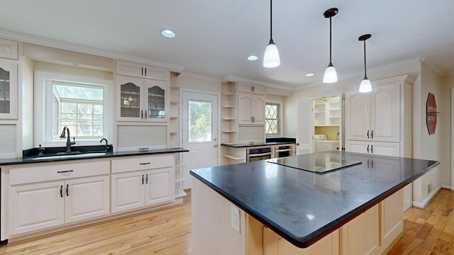 1225 Chaplin Dr, Columbus, GA 31904 - kitchen with open shelves, dark countertops, light wood-type flooring, black electric cooktop, and white cabinetry