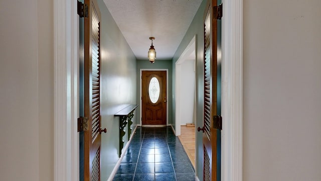 1225 Chaplin Dr, Columbus, GA 31904 - doorway with a textured ceiling and dark tile patterned flooring