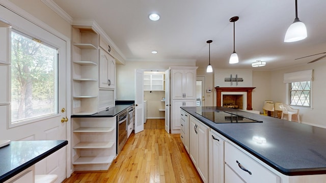 1225 Chaplin Dr, Columbus, GA 31904 - kitchen with open shelves, dark countertops, black electric cooktop, white cabinetry, and a fireplace