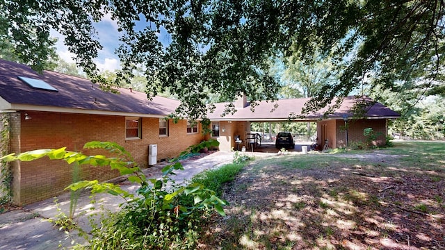 1225 Chaplin Dr, Columbus, GA 31904 - back of house with brick siding and an attached carport