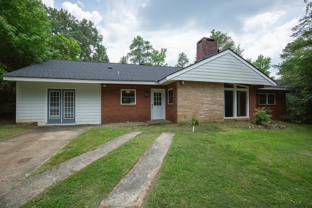 1609 4th Pl, Phenix City, AL 36869 - rear view of property with a chimney, a lawn, and brick siding