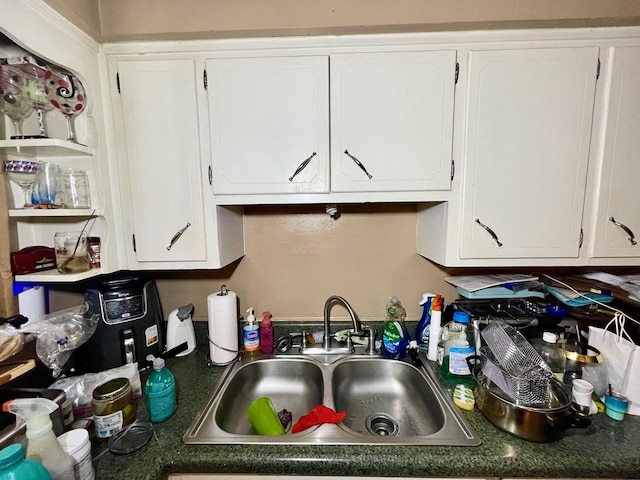 kitchen with white cabinetry and sink