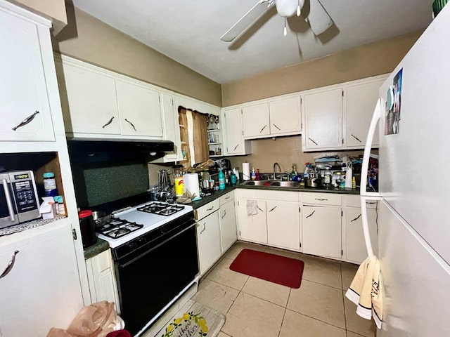 kitchen with white appliances, sink, ceiling fan, light tile patterned flooring, and white cabinetry