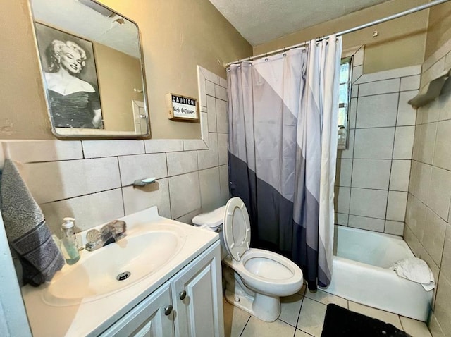 full bathroom featuring tile patterned flooring, shower / bath combination with curtain, toilet, vanity, and tile walls