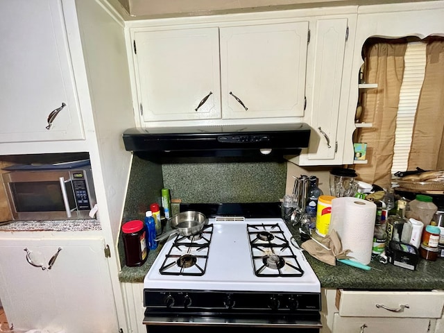 kitchen with white cabinetry and white gas range oven