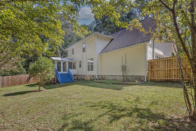 back of house with a lawn