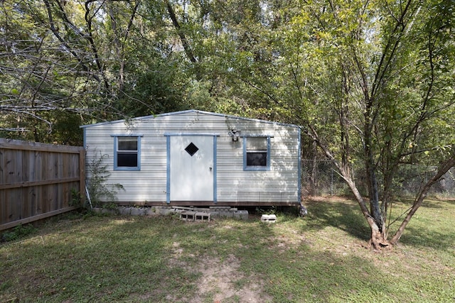 view of outbuilding featuring a yard