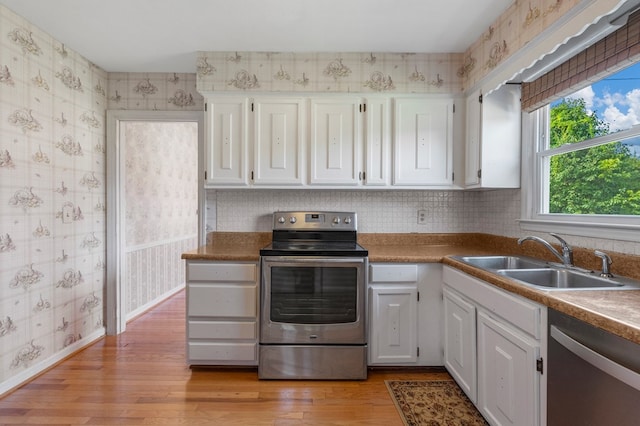 6248 Old Post Ct, Columbus, GA 31909 - kitchen with appliances with stainless steel finishes, wallpapered walls, white cabinetry, and light wood finished floors