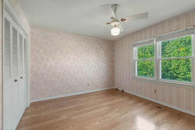 6248 Old Post Ct, Columbus, GA 31909 - unfurnished bedroom featuring light wood-type flooring, a closet, ceiling fan, and wallpapered walls