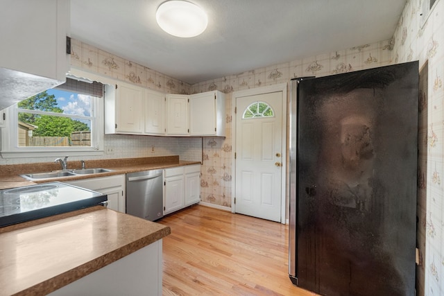 6248 Old Post Ct, Columbus, GA 31909 - kitchen with wallpapered walls, stainless steel dishwasher, plenty of natural light, freestanding refrigerator, and light wood-style flooring