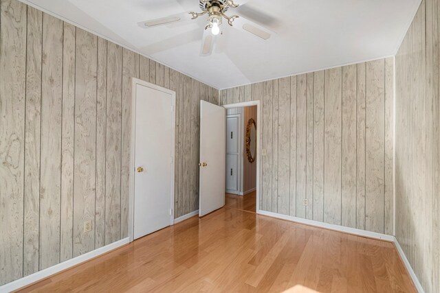 6248 Old Post Ct, Columbus, GA 31909 - empty room with wood finished floors, a ceiling fan, and wooden walls