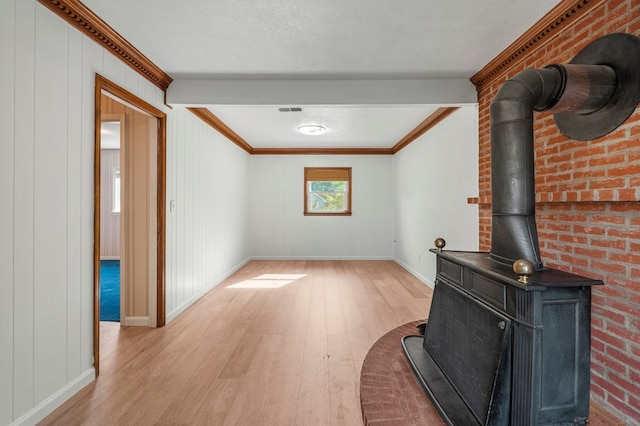 6248 Old Post Ct, Columbus, GA 31909 - unfurnished living room featuring light wood-style flooring, a wood stove, and crown molding