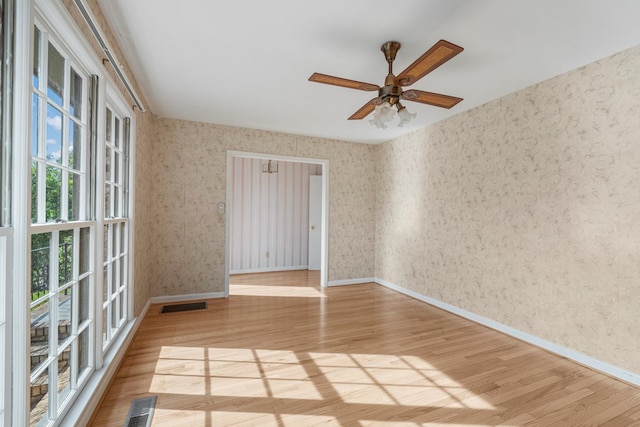6248 Old Post Ct, Columbus, GA 31909 - spare room featuring wood finished floors, wallpapered walls, and ceiling fan