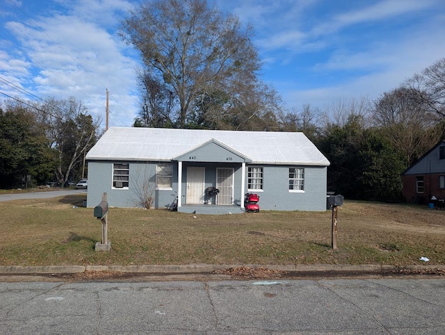 bungalow-style house with a front lawn