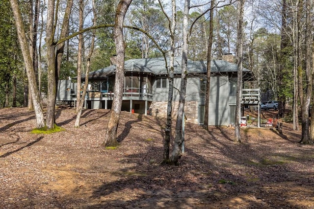 rear view of house with a wooden deck