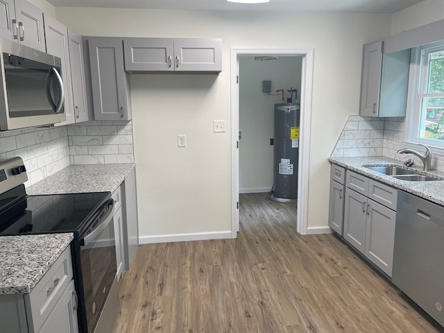 2618 Ogletree St, Columbus, GA 31909 - kitchen featuring stainless steel appliances, water heater, and gray cabinets