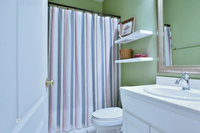 bathroom with tile patterned flooring, vanity, and toilet