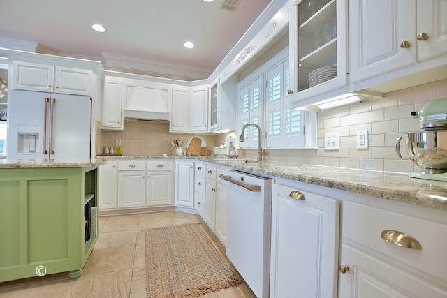 kitchen featuring white cabinetry, dishwasher, light stone countertops, premium range hood, and ornamental molding