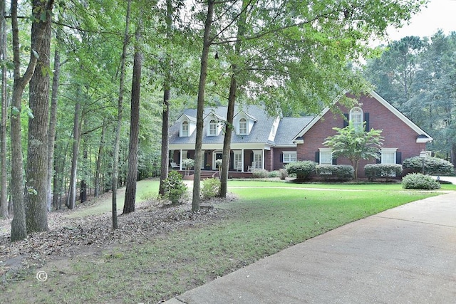 view of front of house with a front yard and covered porch