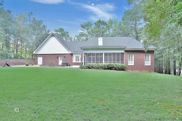 rear view of house with a patio area, a sunroom, and a yard