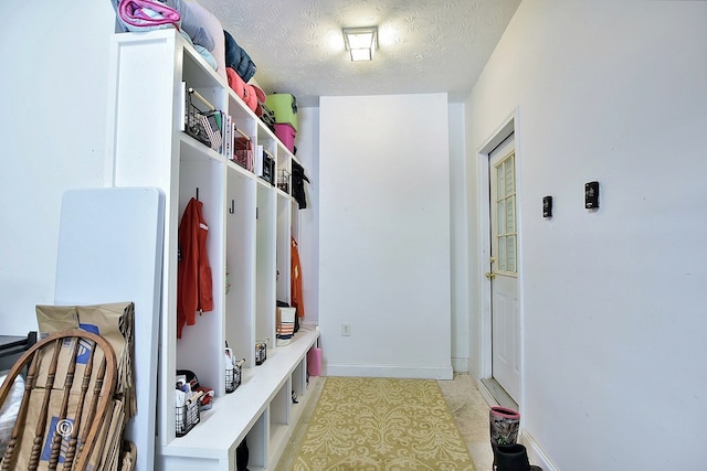 mudroom with a textured ceiling