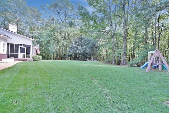 view of yard featuring a sunroom