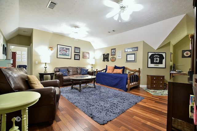 bedroom featuring ceiling fan, dark hardwood / wood-style flooring, lofted ceiling, and a textured ceiling