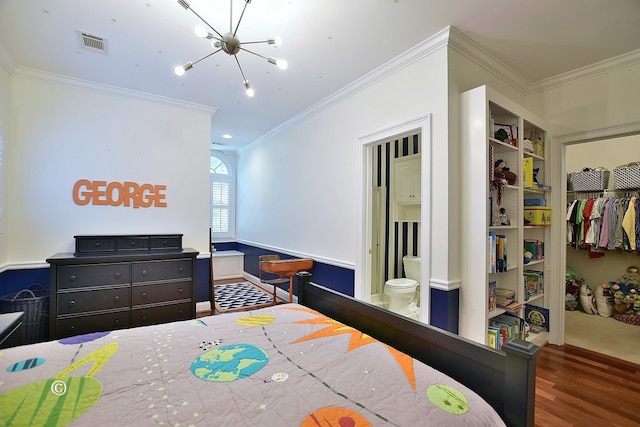 bedroom featuring an inviting chandelier, ensuite bathroom, crown molding, dark hardwood / wood-style flooring, and a closet