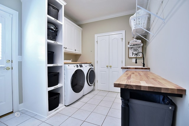 washroom with crown molding, light tile patterned floors, cabinets, and independent washer and dryer