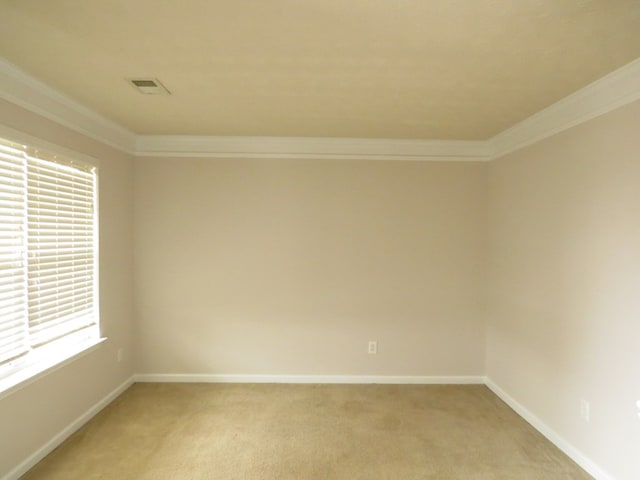 unfurnished room with baseboards, light carpet, visible vents, and crown molding