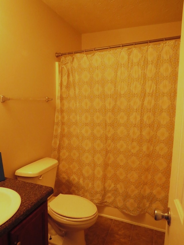 full bathroom featuring vanity, tile patterned floors, and toilet